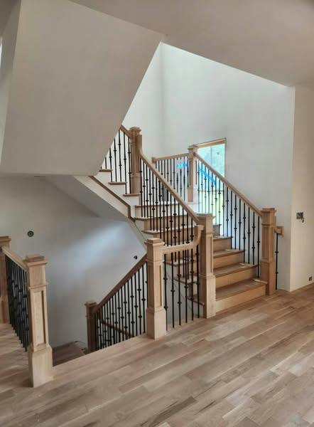 Finished staircase with wood treads, handrail and turned balusters