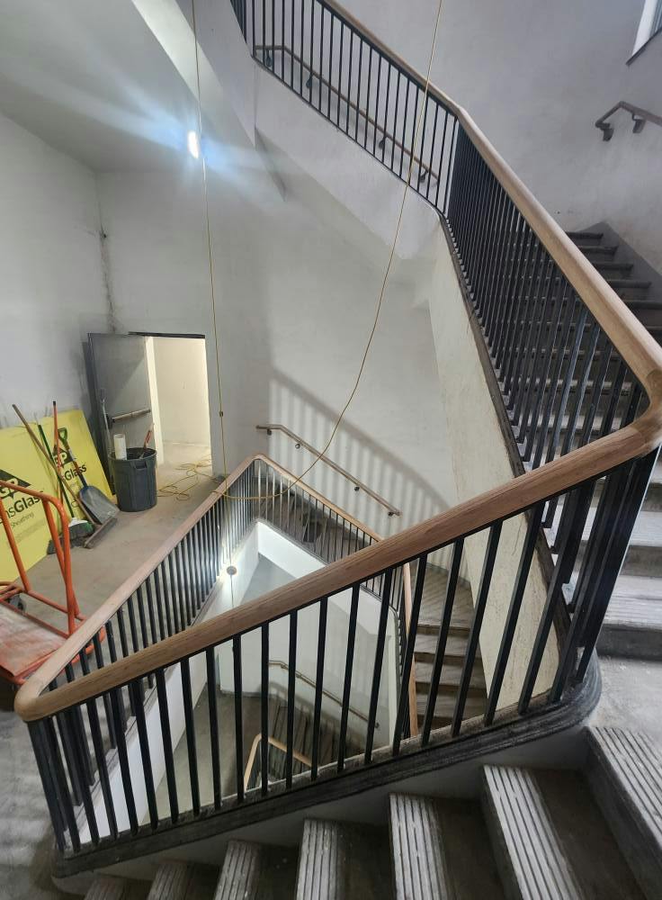 Staircase with metal spindles and cable railing