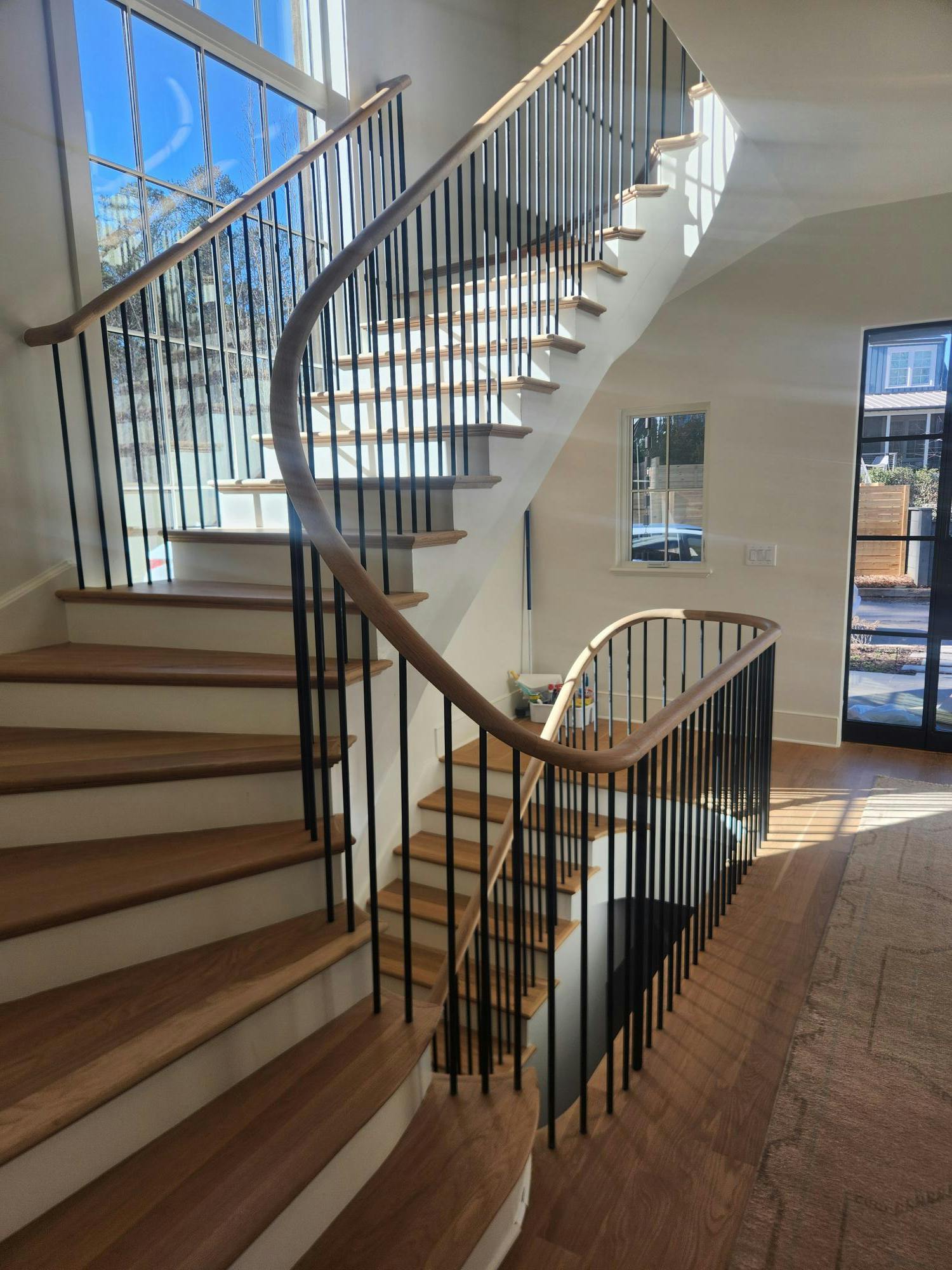 Staircase with metal spindles and cable railing