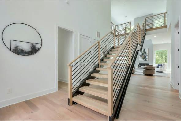 Open-riser staircase with floating wood treads