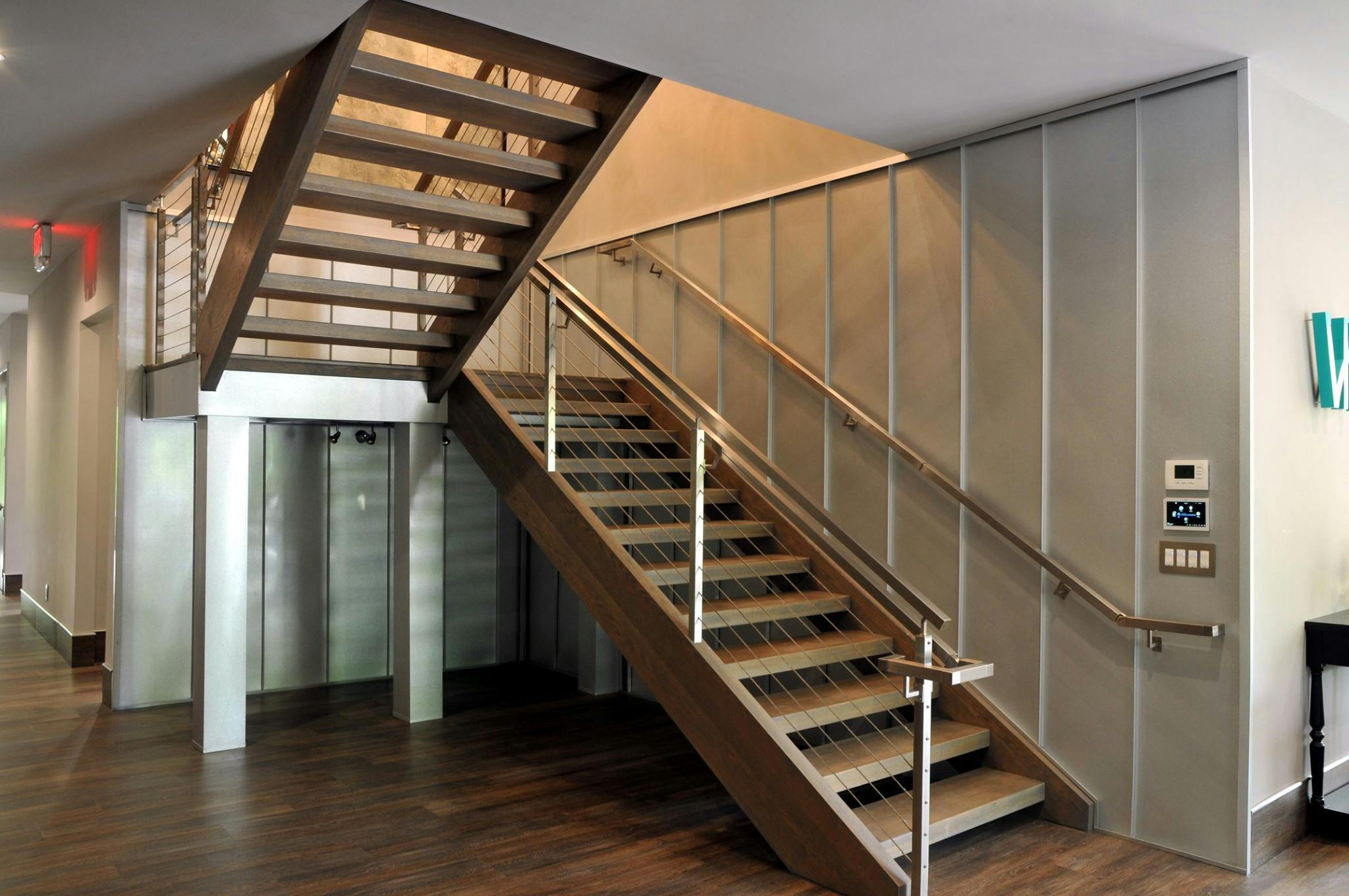 Open-riser staircase with floating wood treads