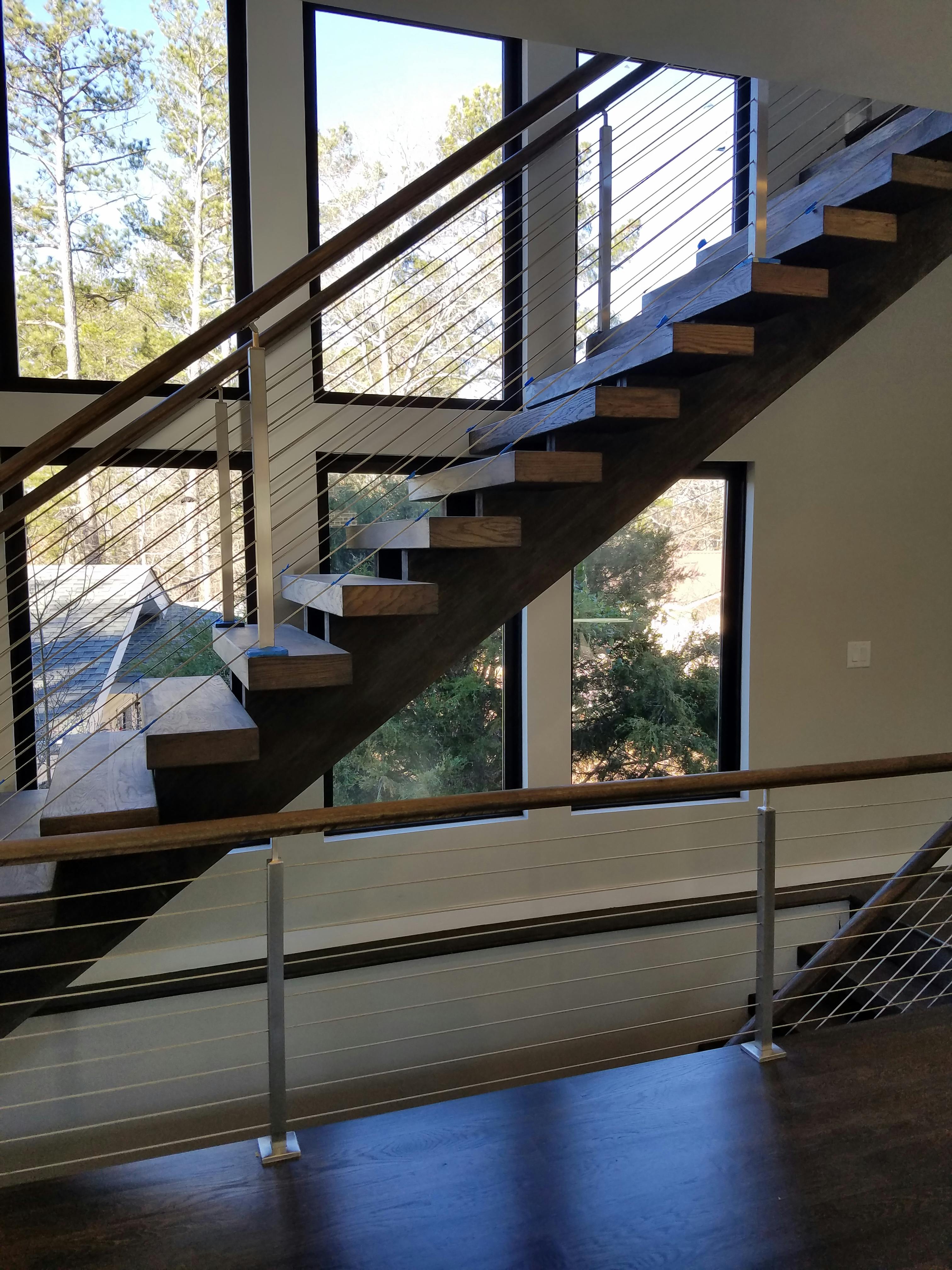 Open-riser staircase with floating wood treads