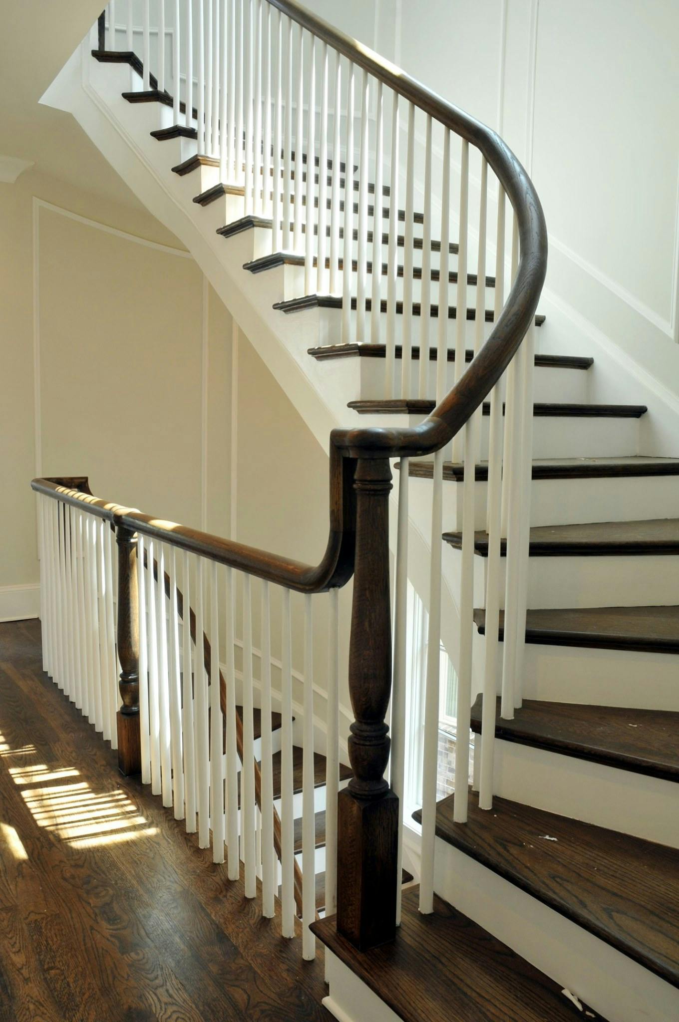 Staircase with white painted balusters and risers