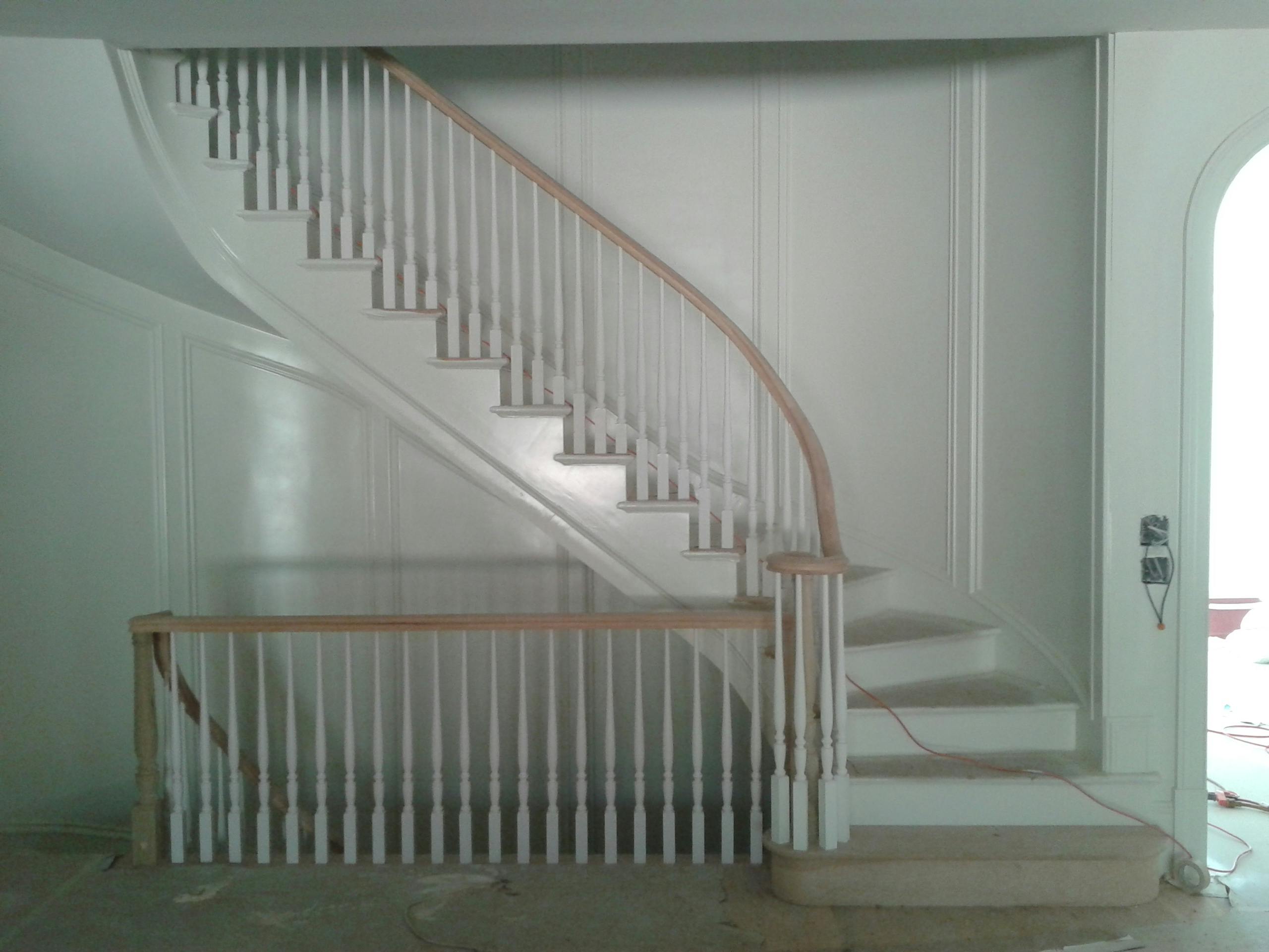 Staircase with white painted balusters and risers