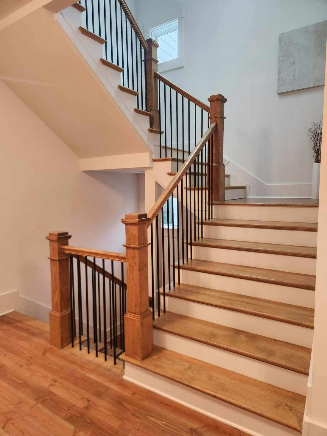 Finished staircase with wood treads, handrail and turned balusters