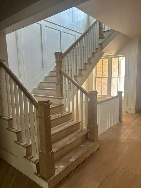 Staircase with white painted balusters and risers