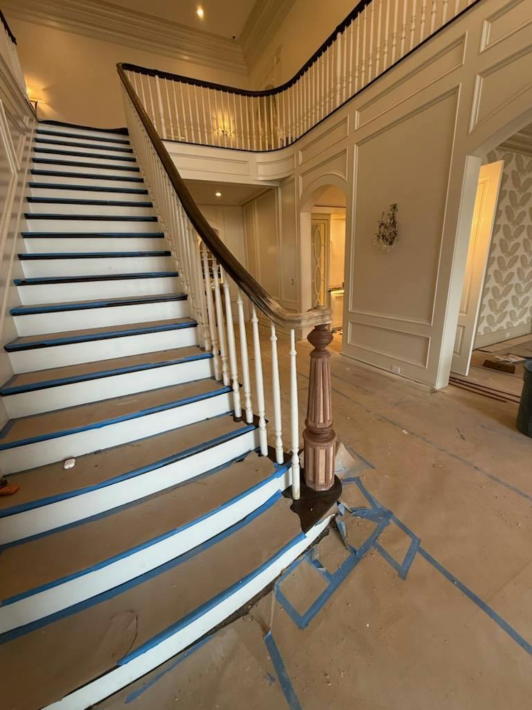 Staircase with white painted balusters and risers