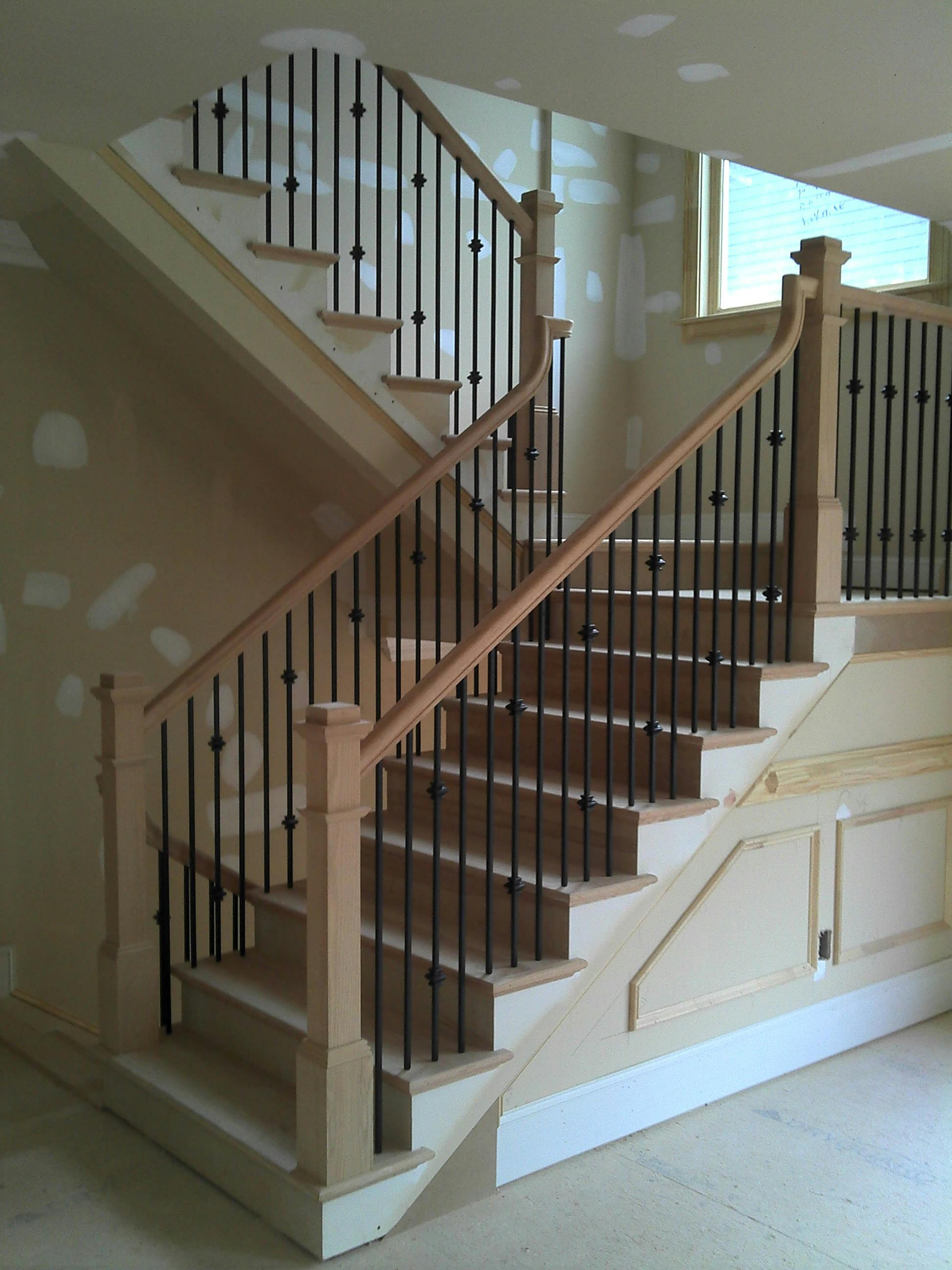 Finished staircase with wood treads, handrail and turned balusters